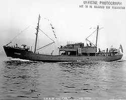 The USS YP-422, a small two-masted vessel with several sailors visible on deck