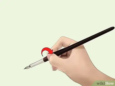 Image titled A person demonstarting how to properly hold a nib holder.