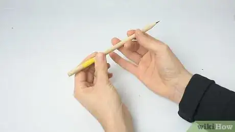 Image titled Spin a Pencil Around Your Middle Finger Step 1