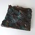 "Boot in bewegter See", 2019, bronze relief, 31 × 31 × 8 cm