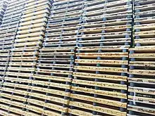 Several large stacks of pallets