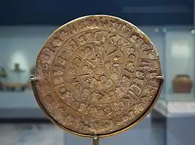 Round clay disc with symbols