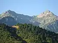 Olonos (on the right), as well as the second highest peak of Erymanthos, Mougila (on the left). View is from the north, showing the col between them.