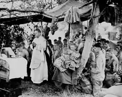 A U.S. Navy chaplain offers Catholic Mass for U.S. Marines at Saipan, June 1944.