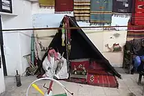 An old man in a tent