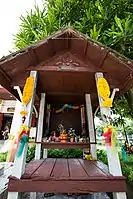 The eye-level height shrine believed to formerly contain the head of Phan Thai Norasing and the damaged figurehead of the barge