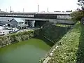 Stone wall that digs into to Mihara Station