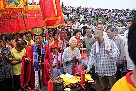 A taoist priest wearing a modern-day taoist's daopao (depicted as a red overcoat), 2017.