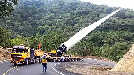 Mercedes-Benz Actros Ballast Tractor pulling Goldhofer hydraulic modular trailer with FTV 300 blade lifter carrying a Windmill blade.