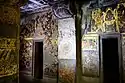 Cave 2 fresco above the right door shows Buddha in Tushita heaven