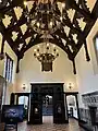Looking to the south end of the hall and through to the small room beyond.