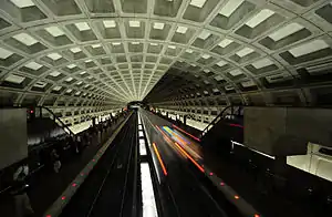 A train departs from McPherson Square station (opened 1977), which has an original ceiling vault design.