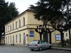 Two-story yellow building with gabled roof