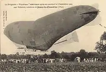 A damaged semi-rigid airship sags under the weight of its gondola.