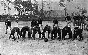 Football practice at University Athletic Field, 1912. Note Thomas Hall in the background