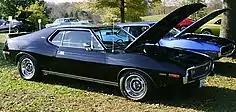 shows a factory original 1973 Javelin AMX finished in black with a 401 "Go Pac"