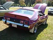 shows the rear end of a 1973 Javelin AMX finished in purple