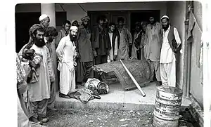 English: Afghans in Peshawar showing off canopy of downed Soviet jet, 1984.