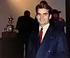 A man in his early twenties smiling at the camera.