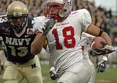 Midshipman safety Hunter Reddick and Lobos wide receiver Hank Baskett