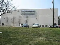 Large, rectangular, concrete structure, with windows on the ground floor