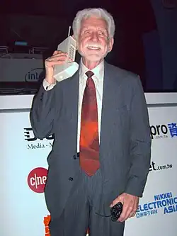 Image 15Martin Cooper of Motorola, shown here in a 2007 reenactment, made the first publicized handheld mobile phone call on a prototype DynaTAC model on 3 April 1973. (from Mobile phone)