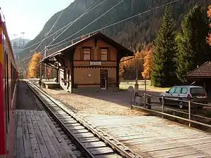 Two-story building with gabled roof next to double-track railway line