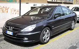 Front-three-quarter view of a four-door car with door mirrors, flush headlights, front foglamps, door mirrors, and alloy wheels