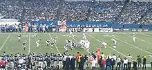 Two football teams on the field in position prior to the play