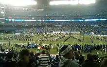 University of Connecticut marching band on the Rogers Centre field, in a formation spelling out U C O N N