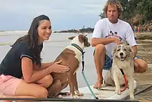 Giaan Rooney and Chris de Aboitiz are pictured with Chris' dogs Rama (left) and Murph (right) at the 2012 Surfing Dog Spectacular, sponsored by VetShopAustralia