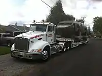 Loaded onto a heavy duty trailer for transport