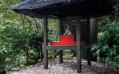 Small pavilion housing a statue of the Buddha