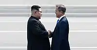 Korean leaders Kim Jong Un and Moon Jae-In shake each other's hands during the 2018 inter-Korean summit.