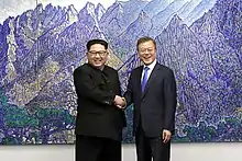 North Korean leader Kim Jong-un and South Korean President Moon Jae-in shake hands inside the Peace House.