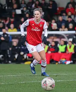 Woman in football kit with ball