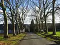 The tree-lined road in front of the Wibin-Gillard castle-farm