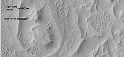 Close-up of circular structure from previous image, as seen by HiRISE under HiWish program Streaks are also visible.