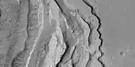 Tilted layers formed when ground collapsed, as seen by HiRISE, under HiWish program.