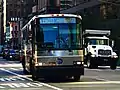 A SIM10 bus on Sixth Avenue in Midtown Manhattan