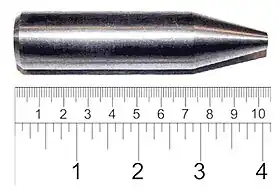 Shiny metallic cylinder with a sharpened tip. The overall length is 9 cm and diameter about 2 cm.