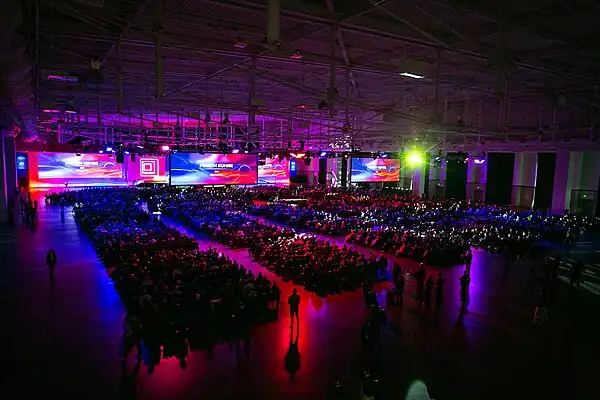 An image of the large number of attendees at the 2023 3DExperience World. The image shows neatly organized seats, filled with participants viewing images and speakers on stage.