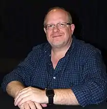 Waid seated, smiling