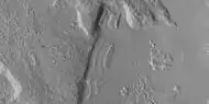 Close view of dipping layers along a mesa wall, as seen by HiRISE under HiWish program