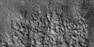 Closer view of ejecta, as seen by HiRISE under HiWish program  Note:  Arrows show examples of boulders sitting in pits.