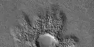 Close view of ejecta of pedestal crater, as seen by HiRISE under HiWish program  Arrow shows one of example of a boulder sitting in a pit.  This image will be enlarged to better show this in the next two images.