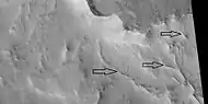 Ridges near the previous image of a ridge network, as seen by HiRISE under HiWish program Arrows point to some ridges.