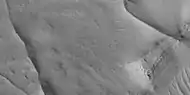 Close view of ridges,  as seen by HiRISE under HiWish program  This is an enlargement of a previous image.  A small mesa in the image displays layers.