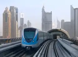 Dubai Metro train departing from Burj Khalifa/Dubai Mall station.