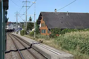 Side platform with town buildings behind it